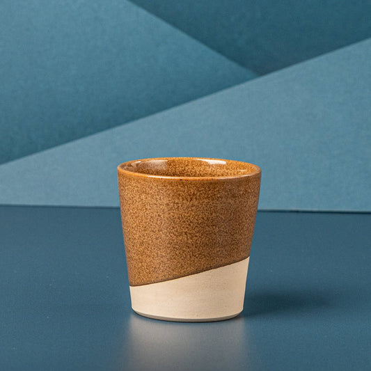 Brown ceramic coffee cup